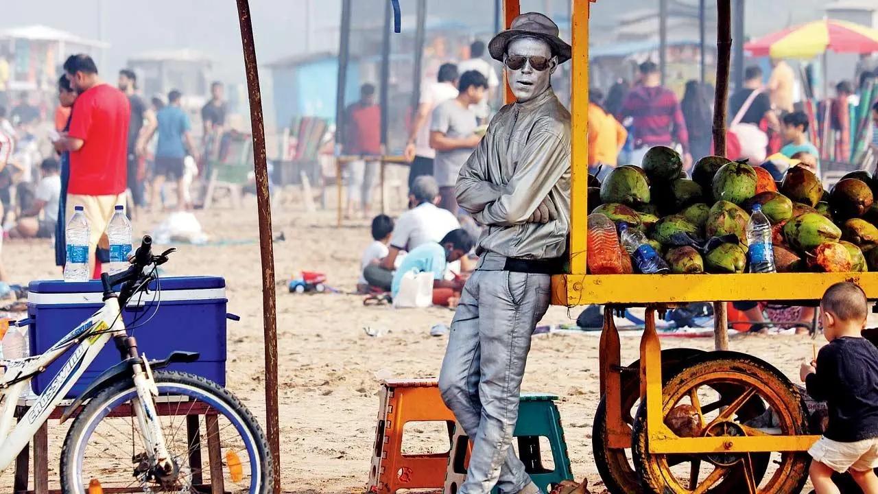 Are you talking to me? A street performer takes a break at a coconut stall at Aksa beach in Malad. Pic/Anurag Ahire